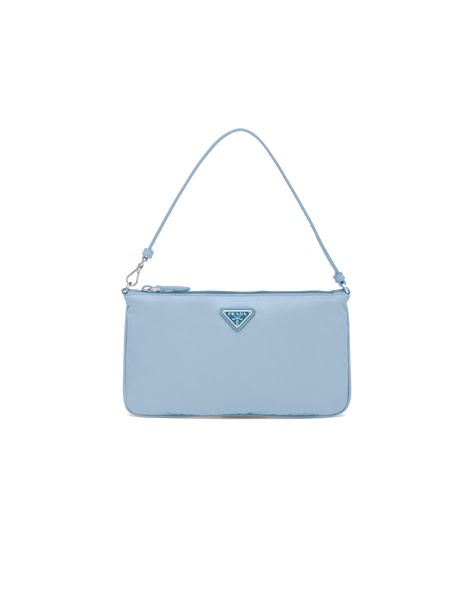 Characterized by a sleek line and emphasized by the iconic enameled metal triangle logo, this mini bag is made of Prada's innovative Re-Nylon fabric produced from recycled plastic materials collected in the ocean. The accessory has a leather strap that lets you also wear it over the shoulder. Tas Coach, Prada Mini Bag, Prada Mini, Bag Prada, Triangle Logo, Bag Trends, Accessory Pouch, In The Ocean, Leather Wristlet