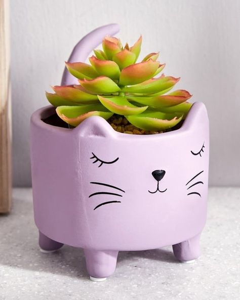 Ceramic Sleeping Cat Planter This cute, small planter is perfect for creating a charming yet peaceful atmosphere in your home. It has an adorable sleeping cat design with its contented expression of relaxation. The planter is easy to maintain and has an artistic flair with functionality. It is perfect to décor your garden or use as a centerpiece in your living room. https://pin.it/5v66rvZRL Cute Flower Pots, Ceramic Cute, Cat Planter, Small Planter, Cute Flower, Cat Design, Flower Pots, Relaxation, Ceramics