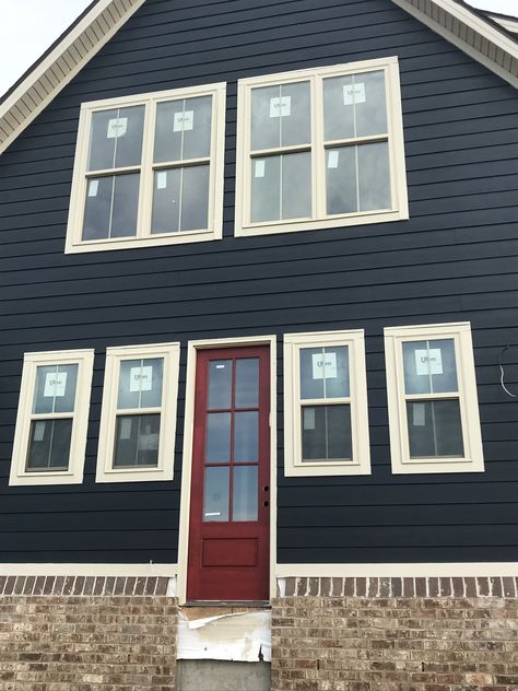 Brigand navy paint and CrabbyApple Sherwin Williams red door Navy House Red Door, Blue Gray Exterior House Colors Red Door, Blue Siding Red Door, Navy House Black Door, Navy Blue House With Red Door, Dark Blue House Red Door, Red Door Blue House, Blue House Red Trim, Black House Red Door