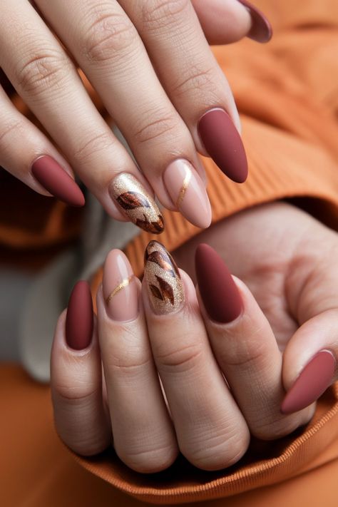 Embrace the cozy vibes of autumn with these stunning almond nails, a perfect blend of elegance and trend. Think deep burgundy and warm taupe shades, intricately adorned with delicate gold foils that mimic falling leaves. These fall nail ideas will elevate your seasonal style, ensuring your manicure stands out. Ready to make a statement this fall? Dive into these chic designs and let your nails shine! #FallNailIdeas #NailArt #AlmondNails #AutumnNails Oval Nails Autumn, Fall Nail Ideas, Warm Taupe, Chic Autumn, Autumn Look, Oval Nails, Falling Leaves, Deep Burgundy, Fall Nail