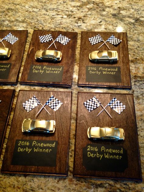 I'm excited about how the prizes for the Pinewood Derby winners. I used a .97 cent plaque from Walmart, chalkboard labels & 3 packages of dollar store cars, & some racing flags I had.  I stained the wood, sprayed with polyurethane coat, sprayed the cars gold(actually my son did that). I hot glued car & flags onto the board. Lastly, I wrote with permanent chalk markers & will fill in the winners names tonight. I hope the boys like them! Awana Grand Prix Car Ideas For Boys, Pinewood Derby Trophy Ideas, Pinewood Derby Decorations, Pinewood Derby Awards, Racing Trophy, Pine Wood Derby Cars Designs Cub Scouts, Fastest Pinewood Derby Car, Small Luxury Cars, Car For Teens