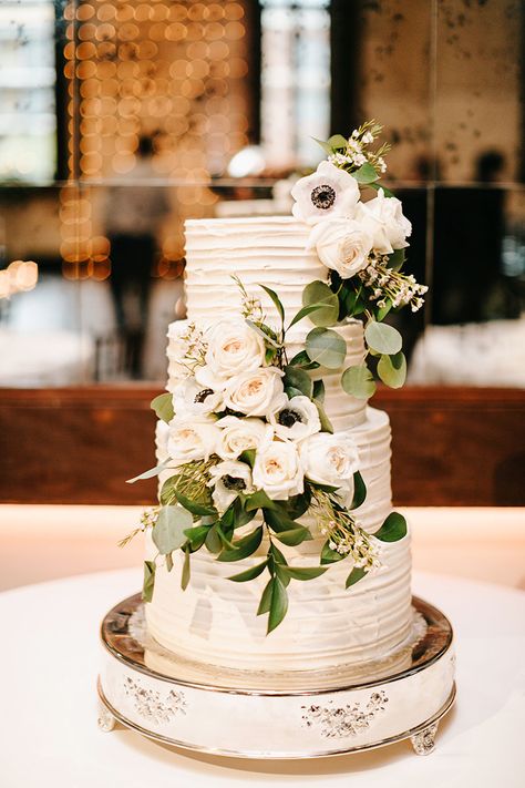 Elegant Four Tiered White Wedding Cake with Ivory Roses & Anemones Wedding Cake Ideas With Greenery, Wedding Cake With Anemones, White Roses Wedding Cake, Anemone Wedding Cake, Wedding Cake Anemone, Wedding Reception Cake Table, Groomsmen Cake Ideas, Wedding Desserts Ideas, Champagne Wedding Cake