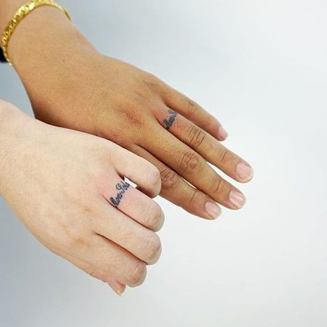 two left hands with wedding ring tattoo scipts Tatoo Ring, Wedding Ring Tattoo Ideas, Ring Tattoo Ideas, Kids Initial Tattoos, Wedding Ring Finger Tattoos, Couple Tattoos Love, Ring Tattoo Designs, Wedding Band Tattoo, Tattoo Band