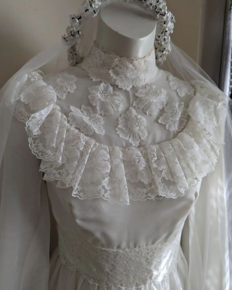 This incredible vintage wedding dress is still looking for her new home! Worn in the early eighties, this 70s inspired piece has a gorgeous matching veil with a floral crown and an underskirt to give that amazing skirt it's proper full shape. It has been incredibly well preserved and the tiny bits of discolouration are very mild and unnoticeable. I think this dress is perfect for a whimsical fantasy wedding or even a spooky goth wedding. It does look a bit spooky at night in the corner of ... Goth Wedding, Vintage Wedding Dress, Fantasy Wedding, 70s Inspired, Floral Crown, Wedding Dresses Vintage, Night In, Vintage Wedding, At Night