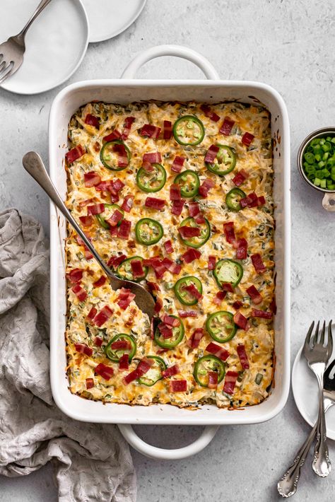 Your favorite appetizer just became a delicious dinner the whole family will love! This Healthy Jalapeño Popper Chicken Casserole is made with chicken, cream cheese, bacon, cauliflower rice, and packs 30g of protein per serving. Chicken Jalapeno Casserole, Jalapeño Popper Chicken Casserole, Jalapeno Popper Casserole, Jalapeno Popper Chicken Casserole, Popper Chicken Casserole, Healthy Pasta Bake, 30g Of Protein, Cauliflower Rice Casserole, Healthy Chicken Casserole