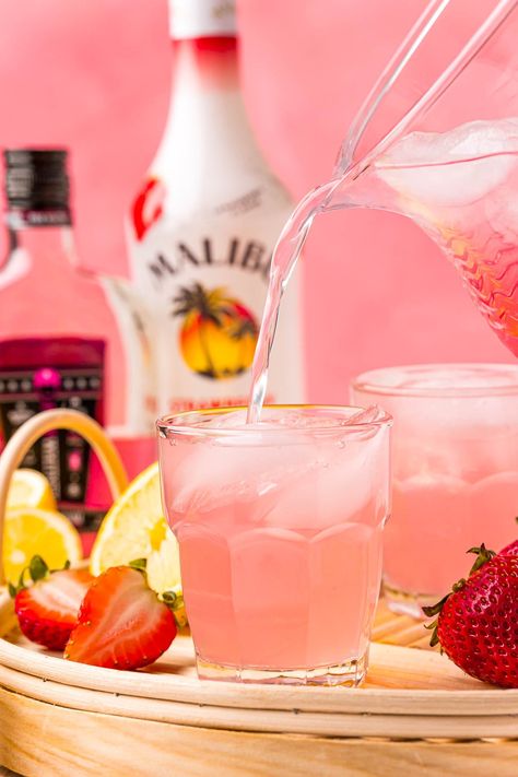 Strawberry Pink Lemonade Vodka Cocktail combines Pink Whitney Vodka, Strawberry Malibu Rum, and Pink Lemonade for the best refreshing drink! This large batch cocktail is ready in just 5 minutes! Bright Pink Alcoholic Drinks, Pink Tropical Cocktails, Strawberry Lemonade Drink Alcohol, Fun Pink Alcoholic Drinks, Strawberry Schnapps Drinks, Pink Whitney Starburst Lemonade Drink, Pink Rum Punch, Easy Pink Drinks Alcohol, Pink Alcohol Punch