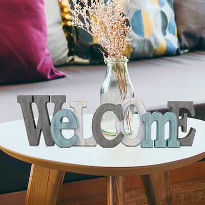 Decorative welcome word decor, distressed finish, and multi-colors design add a rustic touch to your house. The perfect piece to complement the modern, farmhouse, or country-style decor as a decorated indoor accent. | Gracie Oaks Rustic Wood Welcome Letters Sign Cutout Welcome Word Free Standing Table Top Sign Wall Mounted Welcome Letters Decorative Word Sign Wall Decor Wood Welcome Words, Word Decor, Standing Table, Metallic Balloons, Welcome Letters, Globe Decor, Country Style Decor, Modern Western, Sign Wall Decor