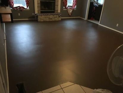 After removing carpet in our living room and main hallway (and later the linoleum from the laundry room), we painted our concrete foundation to look like wood planks. The process is fairly easy, but it can be hard on your knees and back. flooring | diy floors | faux wood floor | diy faux flooring | diy flooring | carpets | diy | diy home decor | diy home flooring | paint | painted floors | painted faux wood Brown Floor Paint, Concrete Living Room Floors, House Tiles Flooring Ideas, Concrete Floors Living Room, Painting Linoleum Floors, Paint Linoleum, Diy Painted Floors, Faux Wood Flooring, Concrete Foundation