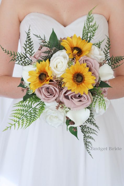 If you have chosen mauve as your accent color, then look no further. This striking brides’ bouquet is the perfect option for those who want to incorporate delicate shades of mauve and white into the design of their wedding. This bouquet is made using an array of gorgeous white calla lilies and roses in mauve and white that contrast beautifully with the sunflowers also included in this collection. Like all of our bouquets, this brides’ bouquet is hand-wired by our in-house florists rather than us Dusty Rose And Sunflower Wedding, Mauve And Sunflower Wedding, Sunflower And White Rose Bouquet, Round Bridal Bouquet, Wedding Flowers Cheap, Lilies And Roses, Mauve Roses, Shades Of Mauve, White Calla Lilies