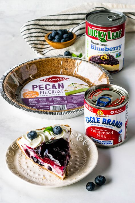 No-Bake Blueberry Cheesecake made with Eagle Brand® Sweetened Condensed Milk, Lucky Leaf® Premium Blueberry Fruit Filling, and Diamond of California® Pecan Pie Crust #ad #nobake #easy #easter #desserts #pie #blueberry #cheesecake #nobakecheesecake #condensedmilk #spring #tart No Bake Cheesecake With Eagle Brand Milk, Easy No Bake Blueberry Cheesecake, Pecan Crust Pie Dessert Recipes, Eagle Brand Cheesecake Recipes, Eagle Brand Cheesecake, Spring Tart, Eagle Brand Recipes, Desserts Pie, Pie Blueberry