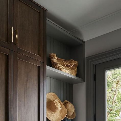 Jenna Cadieux | West Oak Interiors Inc. on Instagram: "Mudrooms are so beneficial in our four season climate, and especially help to make back-to-school mornings and life with pets a bit easier. This space was designed with a combination of millwork finishes for interest and depth. The tall stained wood cabinets resemble furniture, and the lovely grey paint colour on the perimeter cabinetry was carried through on trim and doors throughout the room. My checklist for mudroom design usually includes full and half hanging, shoe/boot storage, a key table, hooks, a few baskets (not too many) and a place to sit. Add a beautiful light fixture, tile and hardware, and this space shows that beauty and function can work perfectly well together.  #interiordesign #interiordecorating #mudroom #mudroomdes Stained Wood Cabinets, Trim And Doors, Key Table, Lovely Grey, Boot Storage, Mudroom Design, Shoe Boot, Grey Paint, Grey Paint Colors