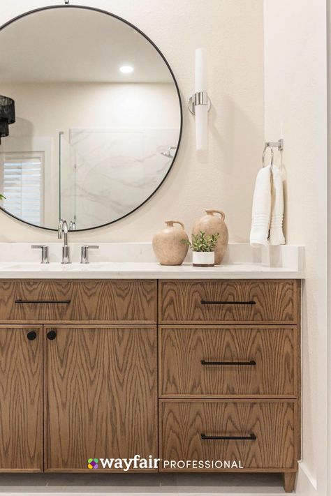 There’s something inherently soothing about warm wood tones. So when @merandrich remodeled this primary bathroom, she knew they would balance the predominantly white space. With the addition of dimmable bath bars, the homeowners can have task lighting for getting ready or a soft glow when enjoying their soaking tub. Are you embracing the warm wood trend for your projects? ��📸: @theenglishden Warm Wood Tones, Mirror Backsplash, Renovation Inspiration, Primary Bathroom, Wood Tones, Bath Bar, Task Lighting, Stone Countertops, Soaking Tub