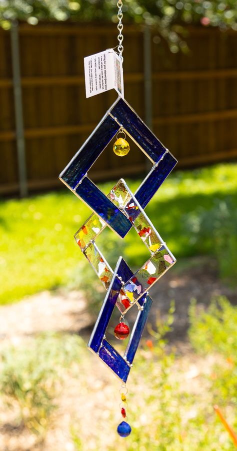 Whether adding a touch of color and sparkle to your garden or simply hanging in your favorite window, this 3 piece stained glass interlocking squares is the perfect choice.  It is handcrafted in the Tiffany style of glass, has touches of decorative solder for interest and colored crystals to top off the sparkle.  Add a solar powered spinner and watch as it creates a dance of color to your garden or window.  Each square measures approximately 5 inches and total length is approximately 24 inches. Scrap Stained Glass Projects, Stained Glass Spinner Patterns, Stained Glass Snowflakes, Stained Glass Spinners, Glass Spinners, Hanging Stained Glass, Stained Glass Gifts, Tin Ornaments, Stained Glass Patterns Free