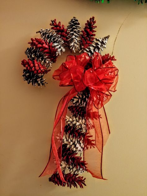 The wreath form and ribbon were from Dollar Tree and the paint was from Walmart. The pine cones are from my yard! Complete for under 5 dollars!! Red Pine Cones, Christmas Wreaths With Pine Cones, Candy Cane Pine Cone Wreath, Pine Cone Candy Cane, Pine Cone Candy Cane Wreath, Pinecone Candy Cane, Pinecone Candy Cane Wreath, Pinecone Wreath Christmas, Pine Cone Wreath Ideas