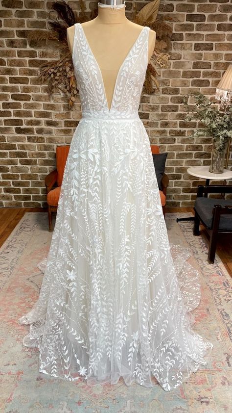 Boho lace a-line wedding dress with plunging neckline, open back, and long train #lifeisbettergilded #gildedbridal #getgilded Floral Sparkly Wedding Dress, A Line Deep V Wedding Dress, Leaf Lace Wedding Dress, Low Cut Wedding Dress, V Neck Lace Wedding Dress, Earthy Wedding Dresses, Rish Bridal, Lace Overskirt, Tulle Overskirt