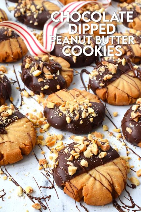 In our home, you cannot go wrong with the classic combination of peanut butter and chocolate! These delicious Chocolate Dipped Peanut Butter Cookies are dipped in melted chocolate and topped with a sprinkling of chopped salted peanuts. These are so easy to make, so whip up several batches and gift them to your friends, neighbours, and coworkers! #peanutbutter #cookies #chocolate #christmas #holiday #baking Dipped Peanut Butter Cookies, Mmm Cookies, Cookies 2023, Bars Cookies, Salted Peanuts, Chocolate Dipped Cookies, Peanut Cookies, Mint Oreo, Dipped Cookies