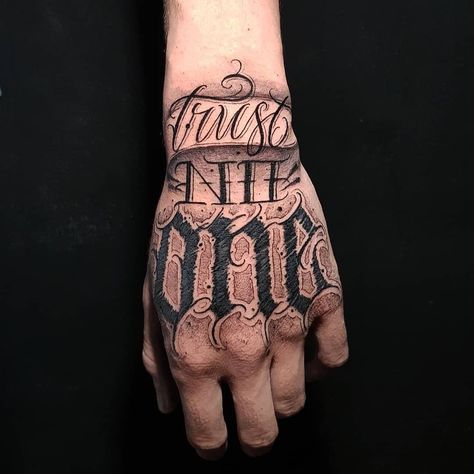 Hand Tattoo Text Men, Trust No One Tattoo Design Fonts, Struggle Tattoo, Chicano Letters, Trust No One Tattoo, Chest Tattoo Lettering, Red Heart Tattoos, One Tattoo, Tattoo Hand