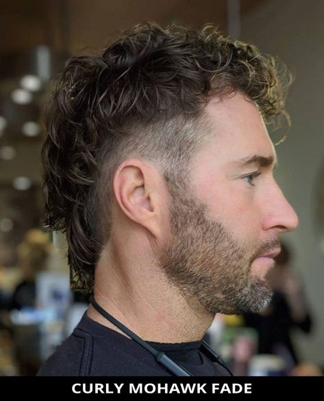 Style your hair into this modern curly mohawk fade for your next cut! Click here to see all of the 22 Popular Mohawk Fade Haircuts for a Flattering Look. // Photo Credit: @elevatedundercuts on Instagram Fohawk Haircut Fade, Long Hair Mohawk, Fohawk Haircut, Mohawk Fade, Curly Mohawk Hairstyles, Curly Faux Hawk, Mohawk For Men, Hockey Hair, Mohawk Haircut