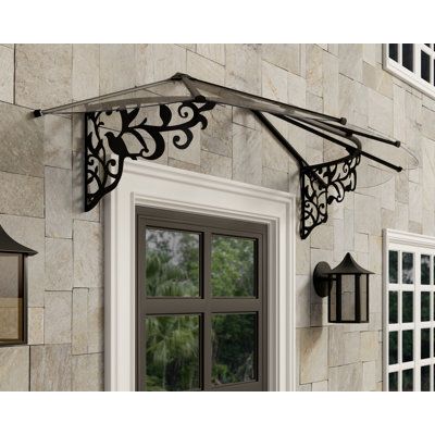 Protect your entry and bring some romance to your home with the 4X6 Lily Door Awning. With rust-resistant aluminum profiles, powder-coated galvanized steel brackets with ornate detailing, and clear panels, the door canopy is virtually maintenance-free. It is simple to assemble and easy to install with the included wall mounting kit whether you use it as a window awning, front door canopy, porch canopy, or garage door canopy. Add value to your home or property with this eco-friendly extension. Th Awning Front Door, Palram Canopia, Door Canopy Porch, Outdoor Window Awnings, Canopy Porch, Window Porch, Front Door Canopy, Polycarbonate Roof Panels, Porch Canopy