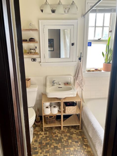 The beautiful porcelain floating sink in the bathroom is one of the apartment's original features. Credit: <a href="https://www.instagram.com/sustainyrself/">Genevieve Wood</a> Nyc Apartment Bathroom, Wood Kitchen Shelves, 1920s Apartment, Minneapolis Apartment, Paris Bathroom, Diy Kitchen Shelves, Rental Bathroom, Floating Sink, Vintage Apartment