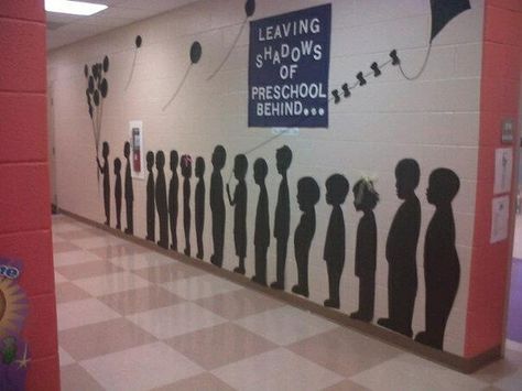 "Leaving Shadows of Preschool Behind." They stood the kids in front of a light and traced their reflections on black banner paper to make full body silhouettes. School Hallway, Hall Decoration, Hallway Displays, Pre K Graduation, Preschool Bulletin, Classroom Board, Black Banner, Preschool Graduation, Kindergarten Graduation