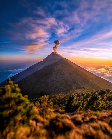 Beautiful view of Acatenango volcano in Guatemala. In the photo you can see the big volcano and smoke is coming out of it and a very colorful sky and surroundings. Acatenango Volcano, Volcano, Guatemala, Vision Board, Travel