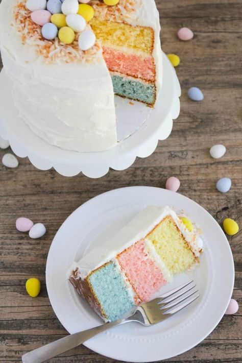 A colorful vanilla cake topped with whipped buttercream and decorated with toasted coconut and mini Cadbury eggs. This Easter egg layered cake is the perfect showstopper for your Easter celebration! #easter #easterrecipes #easterdesserts #cake #cakerecipes #dessert #dessertrecipes #recipes #iheartnaptime Easter Cake Easy, Easter Egg Cake, Easter Cake Recipes, Dessert Parfait, Colorful Desserts, Egg Cake, Slow Cooker Desserts, Easter Baking, Family Easter