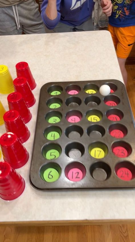 Muffin Tin Match Game 🧁 | prize, entertainment, muffin | Muffin Tin Match Game 🧁 Dad and Family try to bounce ping pong ball into numbered muffin tin for prizes under the corresponding cups. Lots of fun... | By Peter B | Facebook Cupcake Pan Games, Cup Pong Christmas Game, Cupcake Pan Game, Christmas Muffin Tin Game, Prize Game Ideas, Muffin Tin Game, Cupcake Pan Holiday Game, Ping Pong Prize Game, Games To Play For Prizes