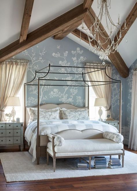 A striking blue-gray floral-patterned wallpaper is the focal point in this French-country bedroom. The bedding on the canopy bed echoes the wallpaper, as do bolster pillows on the bench at the foot of the bed. Matching nightstands and table lamps round out the look. Blue Bedroom Colors, Romantic Blue, Houses In America, French Country Bedrooms, Hgtv Dream Home, French Magazine, Country Bedroom, Country French, Canopy Bed