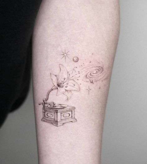 Single needle lily flower gramophone tattoo located on Record Tattoo Ideas, Phonograph Tattoo, Music Box Tattoo, Record Tattoo, Record Player Tattoo, Gramophone Tattoo, Vinyl Tattoo, Galaxy Tattoos, Piano Tattoo