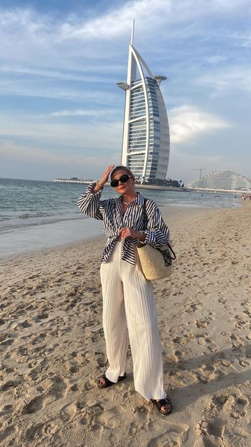 LAURA BYRNES on Instagram: "Can’t wait for the summer ☀️🙌🏻✨🫶 . Outfit details 👇🏻 Shirt: @hm Trousers: @4thandreckless Necklace: @astridandmiyu Bag: @loewe Sunglasses: @celine" Outfits For Dubai Vacation, Loewe Sunglasses Outfit, Dubai Outfits For Women, Dubai Photoshoot, Dubai Outfits, Sunglasses Outfit, Dubai Vacation, Dubai Style, Modesty Outfits