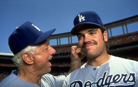 Dodgers manager Tommy Lasorda pinches the cheek of his rookie catcher, Mike Piazza, before a game in June 1993. Piazza finished his career with a .308 batting average, 427 home runs and 1,335 RBIs in 16 seasons, mostly with the Dodgers and Mets. The greatest hitting catcher of all time turned 47 years old today. (V.J. Lovero for SI) Tommy Lasorda, Cheap Poster Prints, Mike Piazza, St Louis Rams, Baseball Girls, Dodgers Baseball, Sports Quotes, Love Pictures, Frame Shop