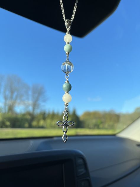 "Decorate your car with our rearview mirror Blue Jade and White Quartz Cross sun catcher car charm! Perfect for hanging from your rearview mirror. It will brighten up your day hanging from your mirror, purse, window, or anywhere else you would choose to hang it from. This would also make a great gift! These beads will sparkle in the sunlight! All of our products are made with high-quality glass, natural stone, or crystal beads.  Length of charm: 4 1/2\" Length of Chain from end to end: 7 Inches Visit us at https://www.etsy.com/shop/BWCharms?ref=shop_sugg for more beautiful car charms to choose from Please like us on Instagram! Instagram.com/beautifullywildllc  If you don't see something you are looking for, we do take special requests. Thank you for shopping our small business, we are happ Rearview Mirror Charms Diy, Beaded Car Mirror Hanger, Car Charms Diy, Car Rear View Mirror Decor, Mirror Purse, Beaded Car Charms, Car Mirror Decorations, Crystal Car Charms, Car Hanging Accessories