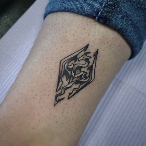 Minimalist Skyrim Tattoo, Minimalist Video Game Tattoo, Small Geek Tattoos, Simple Skyrim Tattoo, Skyrim Symbol Tattoo, Skyrim Inspired Tattoos, Skyrim Traditional Tattoo, Skyrim Logo Tattoo, Nuka Cola Tattoo