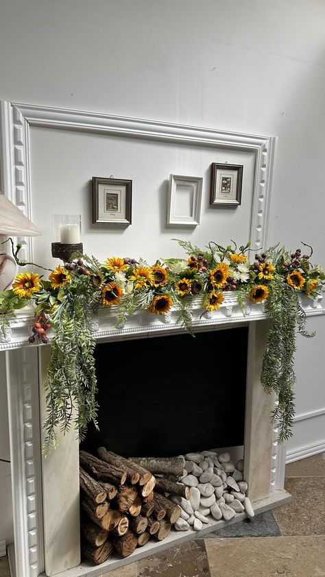 Brighten up your fireplace with the vibrant beauty of our artificial sunflower garland. This eye-catching garland is carefully crafted to bring the essence of summer into your home. Each sunflower is meticulously designed to mimic the natural look and texture of real flowers, creating a lifelike and stunning arrangement. The garland is further complemented by lush green foliage that adds depth and realism to the overall design. Perfect choice for placing it: - above a fireplace - on a mantel - dining table - windowsill Height: 30 cm / 11,8 inches  Width: 125 cm / 49,2 inches  Perfect choice for placing above a fireplace, on a mantel, or even as a spring or wedding table centerpiece.  ✨ Customization is available, so if you wish to make any changes - feel free to message us  ✨All items are Mantel Floral Arrangements, Fireplace Decor Summer, Sunflower Table Centerpieces, Mantel Flowers, Spring Fireplace Decor, Sunflower Garland, Planters Indoor, Summer Mantel, Fireplace Garland