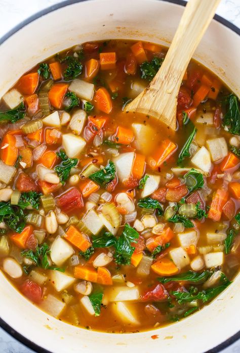 This Harvest Vegetable Soup is a great way to use up those garden veggies! It's made with garlic, onions, celery, carrots, turnips, and kale that are simmered in a savory vegetable broth flavored with Italian spices. This soup is also made with canned diced tomatoes and cannellini beans. It's vegan, gluten free, and dairy free. This healthy soup is a great weeknight dinner, or can be portioned out for lunches throughout the week. It also freezes well and can be enjoyed at a later time! Celery Carrot Soup, Harvest Vegetable Soup, Carrot And Celery Recipes, Kale And Bean Soup, Turnip Vegetable, Kale Vegetable, Healthy Harvest, Turnip Recipes, Celery Recipes