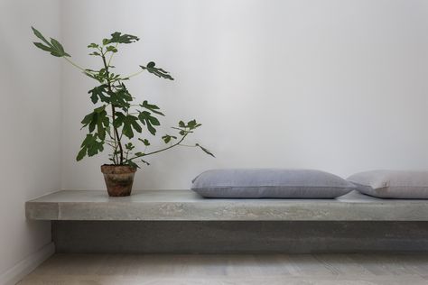 Concrete bench. Gold & Gray Apartment by Richard Lindvall. © Mikael Lundblad. Gray Apartment, Concrete Bench Seat, Concrete Bench, Timeless Architecture, Concrete Furniture, Built In Bench, Floating Wall, Banquette, Living Room Inspiration