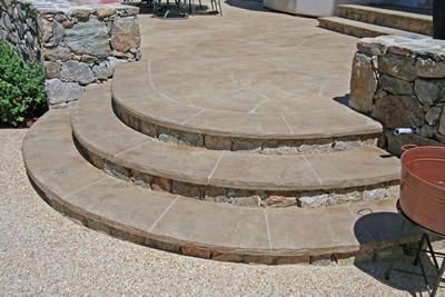 Concrete steps work with natural stone to create this one-of-a-kind ranch style look.  New England Hardscapes Acton, MA Concrete Stairs Outdoor, Patio Surfaces, Curved Steps, Patio Step, Stairs Outdoor, Deck Step, Curved Patio, Stone Deck, Front Porch Steps