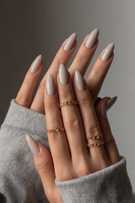 These almond-shaped nails are painted in a soft, sophisticated taupe shade for a timeless and elegant look. #AlmondNails #TaupeNails #MinimalistNails #NailArt #Manicure #GelNails #NailPolish #ShortNails #NaturalNails #ShortNaturalNails Fall Subtle Nails, Simple Tan Nails, November Nail Design Ideas, September Nails 2024 Simple, Tan Neutral Nails, Fall Classic Nails, Nails One Color Simple Classy, Fall Nails Trendy Almond, Simple Fall Wedding Nails