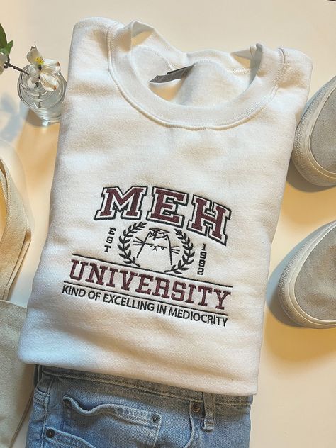 MEH University Embroidered Sweatshirt , True To Size, Unisex Sizing. Perfect For Fall! MEH University Embroidered Sweatshirt | Meh Sweatshirt | College Crewneck | Meh | Funny Sweatshirt | Cute Sweatshirt | Back To School Crewneck Design Ideas, University Hoodies, Crewneck Aesthetic, Hoodie Design Ideas, College Crewneck Sweatshirts, College Crewneck, College Sweater, Kawaii Sweatshirt, Apparel Design Inspiration