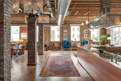 This NYC loft has hardwood floors, exposed brick, open ductwork, exposed ceiling rafters, stan-alone columns, stainless steel kitchen counters, leather chairs and an oriental runner rug. Loft Apartment Designs, Industrial Apartment Decor, Urban Industrial Decor, Loft Designs, Nyc Loft, Loft Ideas, Trendy Apartment, Brick Loft, Vintage Interior Design