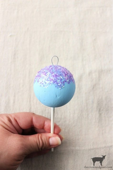 Easy DIY Cake Pop Christmas Ornaments-The Crowned Goat Gumdrop Ornaments Diy, Dessert Christmas Tree Ornaments, Cotton Candy Ornaments Diy, Diy Candy Land Ornaments, Donut Ornament Diy, Candy Land Ornaments Diy, Fake Cake Pops Diy, How To Make Fake Cake Pops, Diy Gingerbread Ornaments Tree Decorations