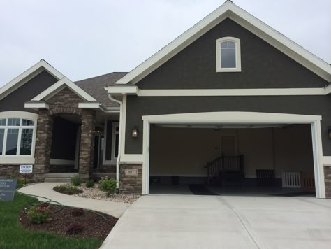 dark grey stucco exterior, white trim, nice stone entrance MABA Parade 2014 Gray Stucco Exterior, Grey Stucco, Stucco House Colors, Stone Entrance, Exterior Stucco, Grey Exterior House Colors, Stucco Colors, Paint Trim, Theme Dark