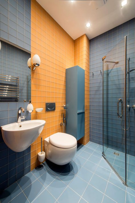 Contemporary Bathroom with Orange and Blue Backsplash  Based on a “divide and conquer” approach, color-blocking is one of the best methods to create a contemporary and engaging look as demonstrated by this bathroom in Moscow. Blue And Orange Bathroom, Blue Glass Tile Bathroom, Glass Tile Backsplash Bathroom, Hgtv Bathroom, Orange Bathrooms Designs, Glass Mosaic Tile Backsplash, Glass Tile Bathroom, Orange Bathroom Decor, Master Bath Design