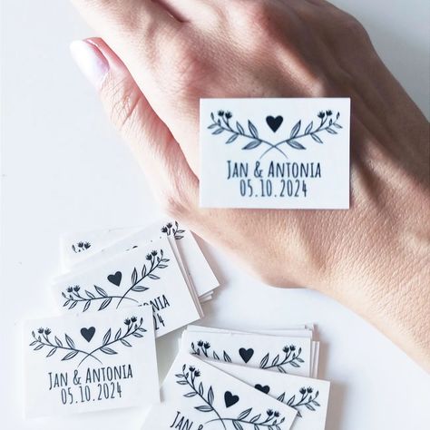 The Ultimate Wedding Souvenir: Temporary Tattoos for Guests 💕 Recently, I had an intriguing thought: wouldn't it be amazing if wedding couples could offer their guests temporary tattoos featuring the couple's names and wedding date? 💒 Imagine the fun and excitement this would bring to the celebration! It's a unique and memorable way for guests to feel even more connected to the special day. Thankfully, these tattoos are washable, so everyone can enjoy the moment without any long-term commitm... Wedding Photos With Guests, Wedding Temporary Tattoos, Elegant Ballroom, Temporary Tattoo Paper, Memories Photo, Tattoos Unique, Garden Ceremony, Wedding Souvenir, Enjoy The Moment