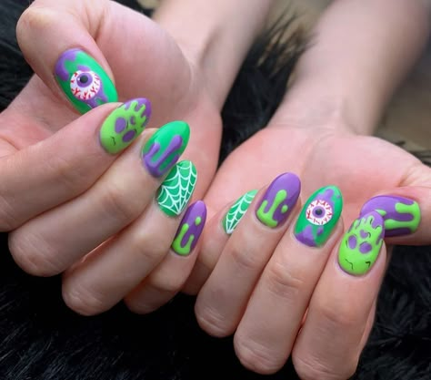 Tropical Rainforest Nail Art with Leaves, Flowers, and Parrots Pastel Horror Nails, Monster Nails Halloween, Halloween Pastel Nails, Pastel Goth Nail Art, Monster Nail Art, Kawaii Halloween Nails, Neon Halloween Nails, Pastel Halloween Nails, Pastel Goth Nails