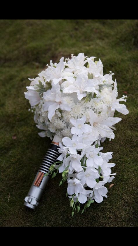 Lightsaber bouquet Lightsaber Bouquet, Lightsaber Wedding, Planning 2025, Star Wars Themed Wedding, Red Lightsaber, Star Wars Wedding Theme, Bouquet Holder, Star Wars Wedding, Wedding Elements