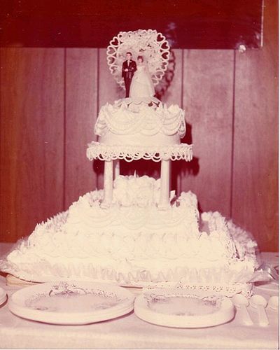 1970's wedding cake through rose colored filter. 1970s Wedding Cake, 1980s Cake, 1990s Wedding, Cake Pillars, Old School Wedding, Fountain Wedding, Fountain Wedding Cakes, Bakery Style Cake, 1980s Wedding