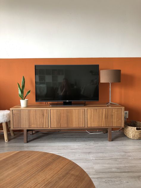 Exploring Bold and Beautiful Wall Paint Colors Accent Wall Color Block, Orange Statement Wall, Rust Wall Color Living Room, Orange Paint Living Room, Mid Century Living Room Paint Colors, Orange Feature Wall Living Room, Rust Orange Living Room, Burnt Orange Living Room Walls, Orange Wall Living Room