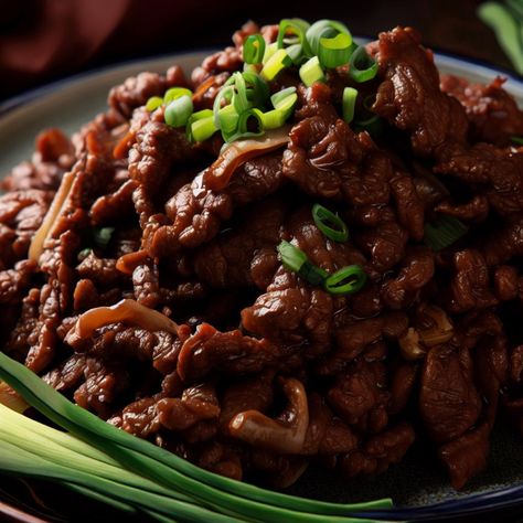 This summery Mongolian Beef and Spring Onions recipe features tender flank steak coated in a flavorful sauce with a hint of ginger and garlic. The dish is quick and easy to prepare, making it perfect for a delicious weeknight dinner. The beef is marinated in a mixture of soy sauce, dark brown sugar, and water, then coated in cornstarch before being fried until crispy. Tender Flank Steak, Spring Onion Recipes, Beef Flank Steak, Dark Brown Sugar, Mongolian Beef, Spring Onions, Flank Steak, Spring Onion, Weeknight Dinner